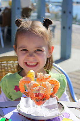 child enjoying shrimp cocktail appetizer