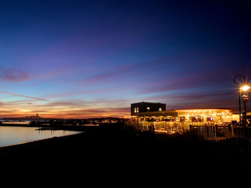 Sam's Chowder House lit up at sunset