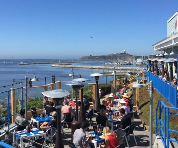 outdoor oceanfront dining patio at Sam's Chowder House on a sunny afternoon