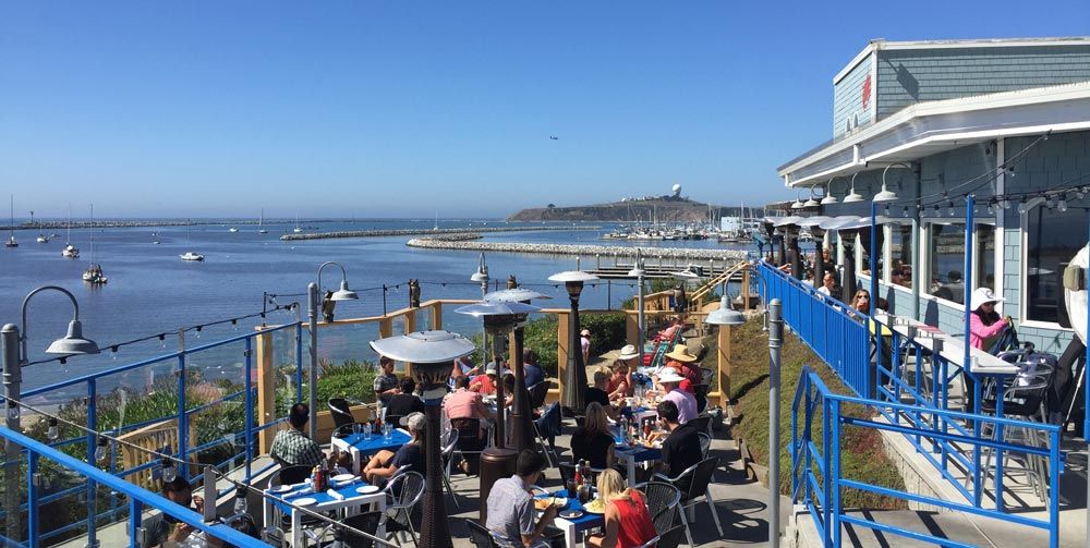 outdoor oceanfront dining patio at Sam's Chowder House on a sunny afternoon