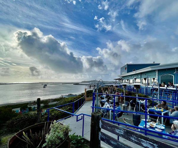 outdoor dining ocean view with dramatic clouds