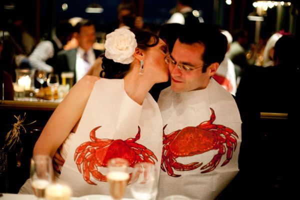 Tender moment between newlyweds at reception lobster clambake dinner
