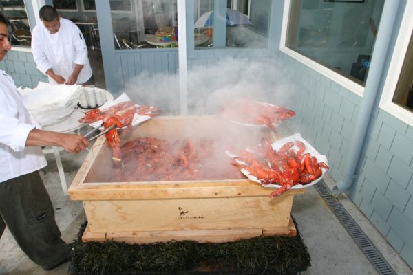 Lobster being removed from steamer box for lobster clambake