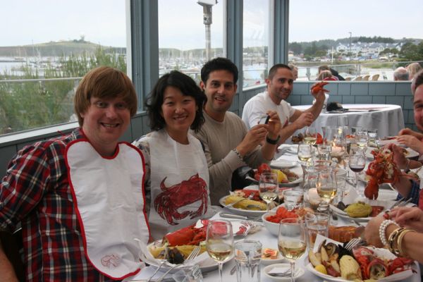 Friends enjoy lobster clambake feast in private room with ocean view
